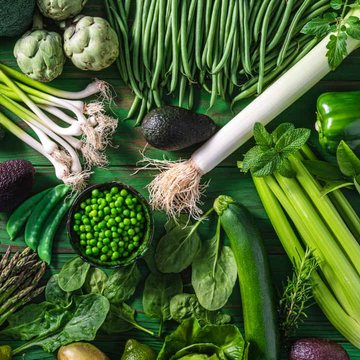 Fresh green vegetables, peas, celery and avocado on a table