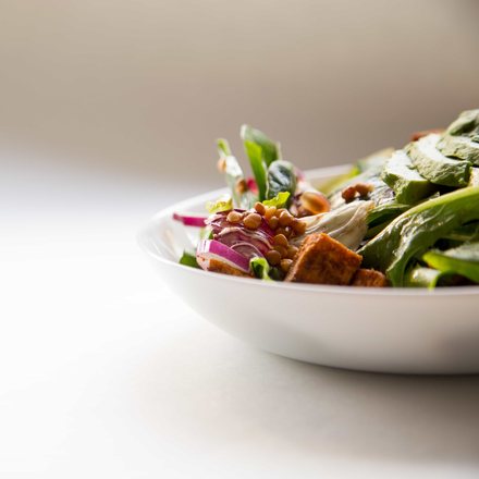 Fresh leafy salad in a white bowl