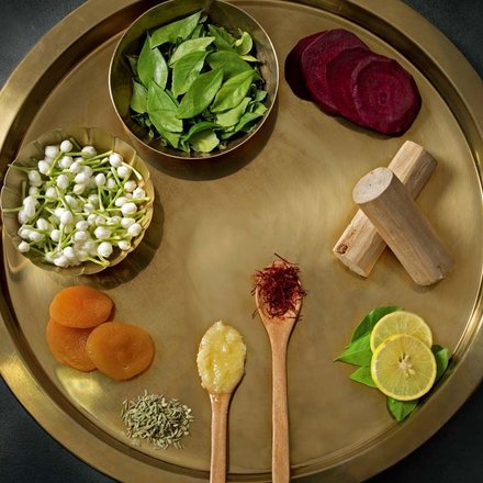 Brass plate of herbs, beetroot, lime and spices