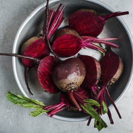 Fresh beetroot with leaves in a metal bowl