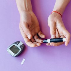 Person checking their blood sugar with a glucose meter