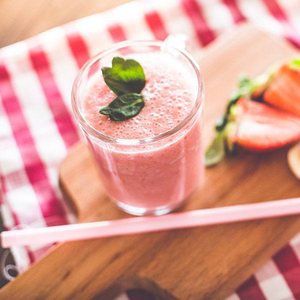 Strawberry smoothie in a glass with fresh mint